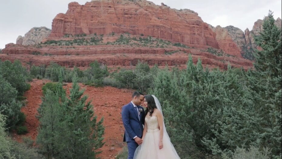 Bride and groom embracing at the bottom of a canyon