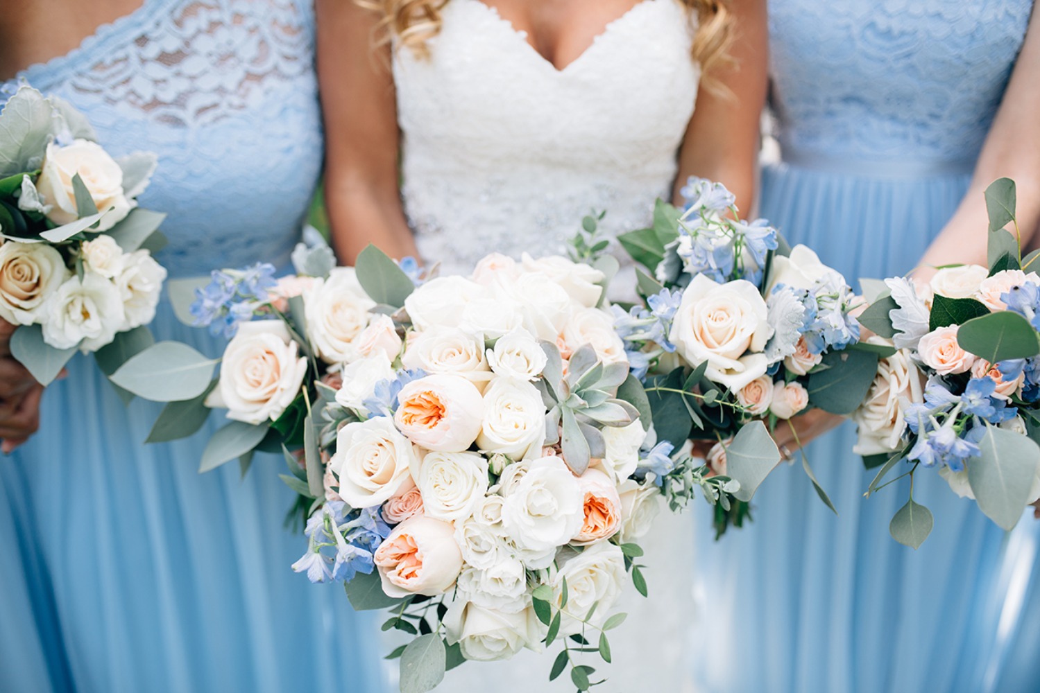 ice blue bridesmaids with blush and blue bouquets
