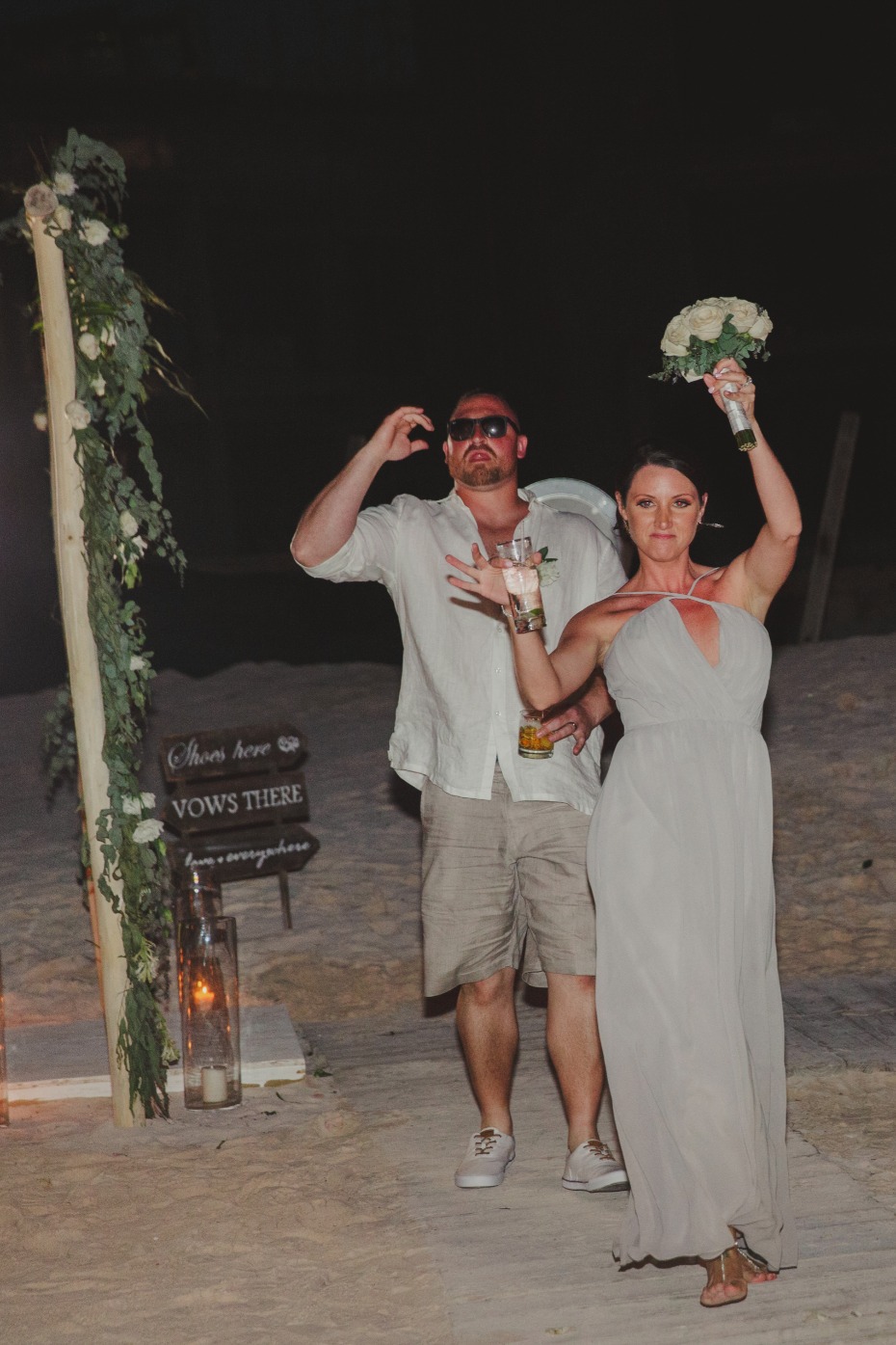 Bride and groom celebrate after beach wedding ceremony
