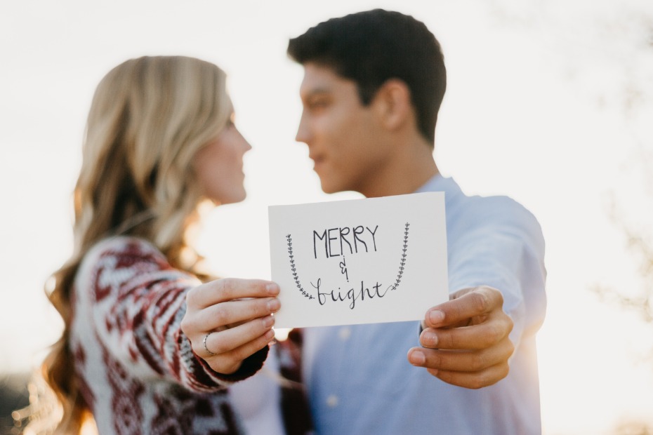 Couple holding holiday cards