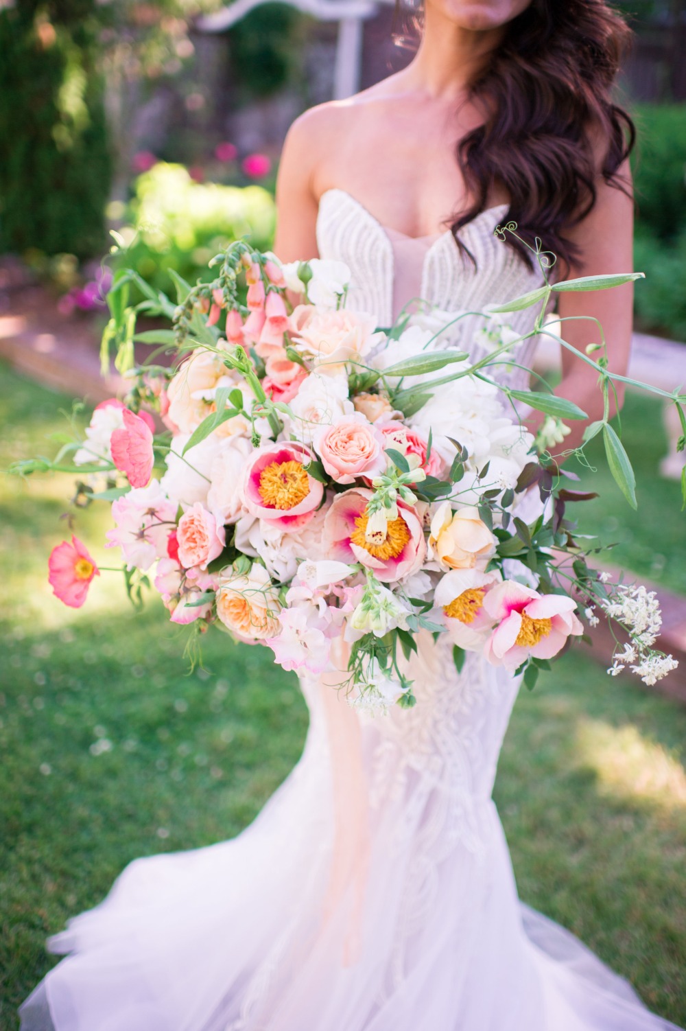 Bride holding a large pink and white wedding bouquet