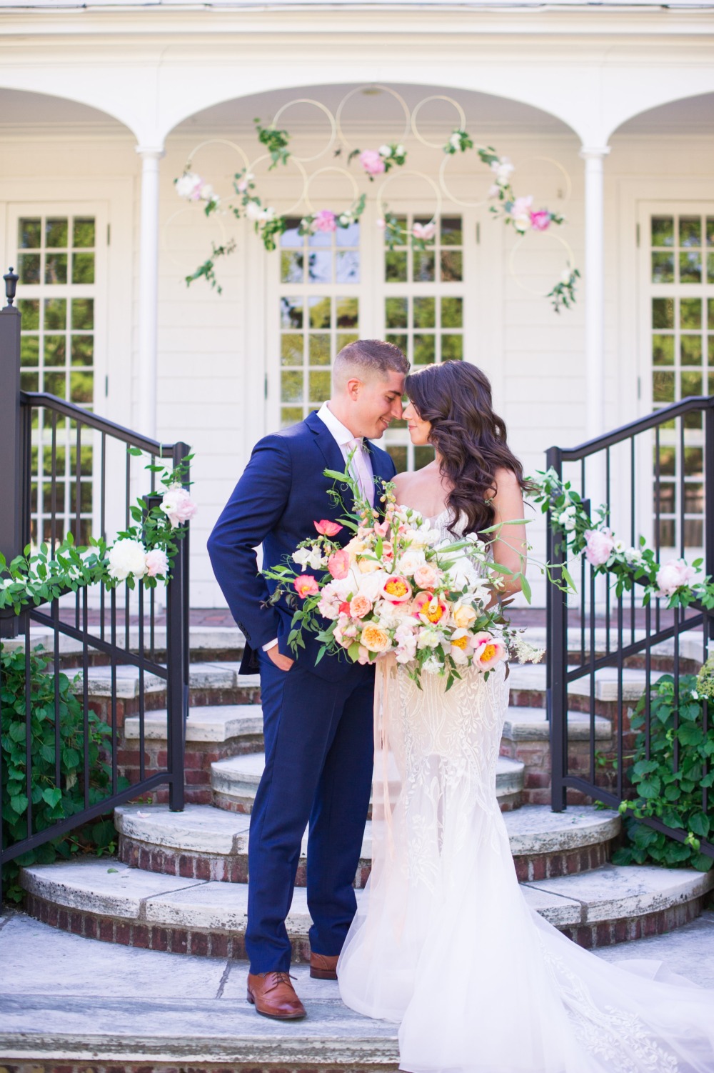 Bride and groom embrace at their outdoor wedding venue