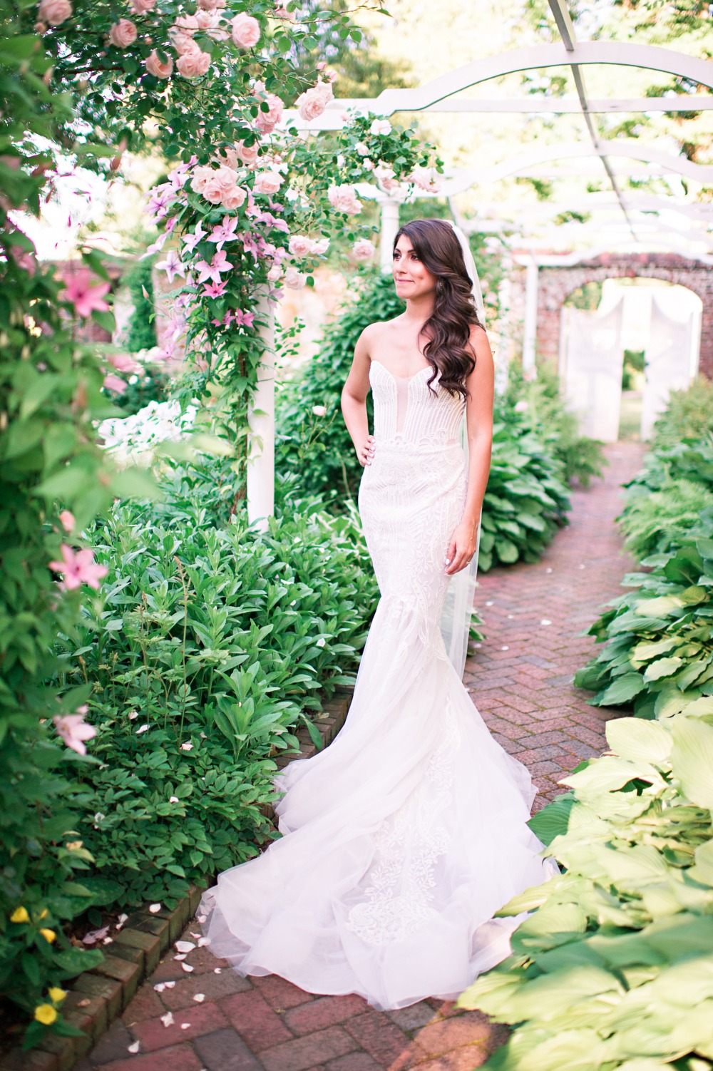 Bride in gorgeous lace wedding gown, garden setting