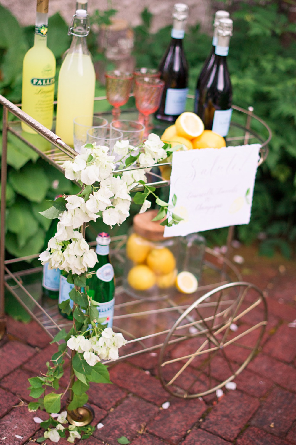 Elegant drinks cart with lemons and floral arrangement