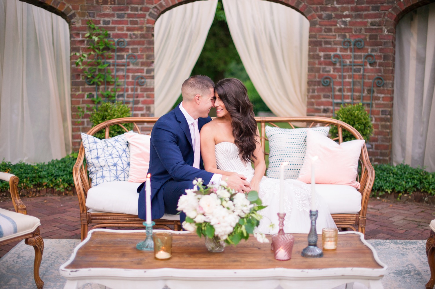 Newlyweds share a loving moment on a romantic outdoor lounge