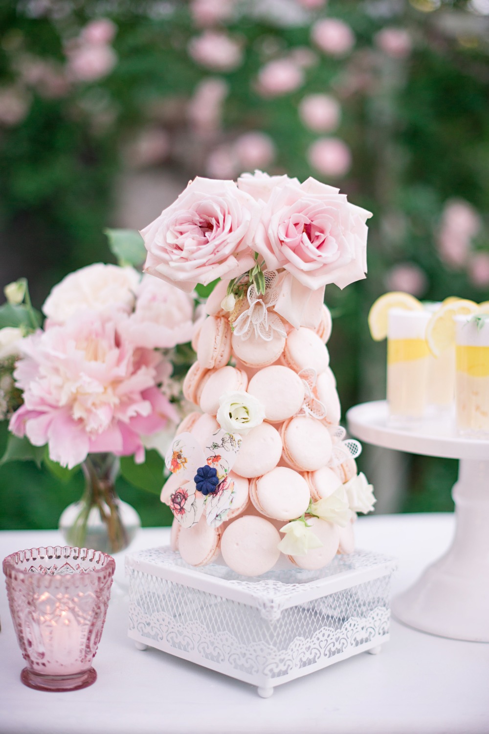 Elegant macaron tower with pink roses and floral accents