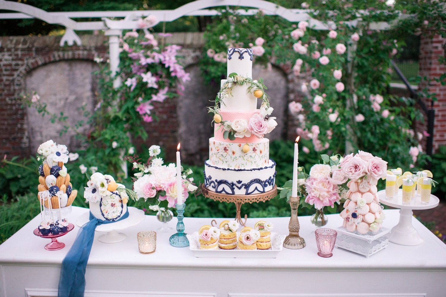 Elegant wedding dessert table with tiered cake and floral decor
