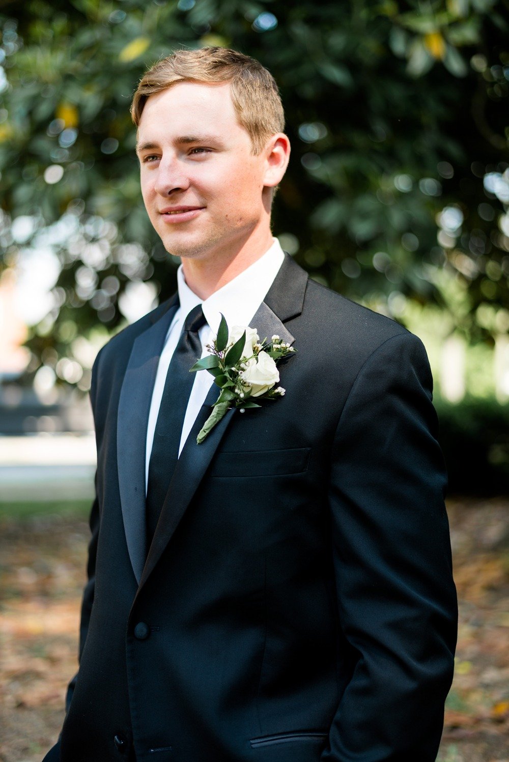groom in classic black suit