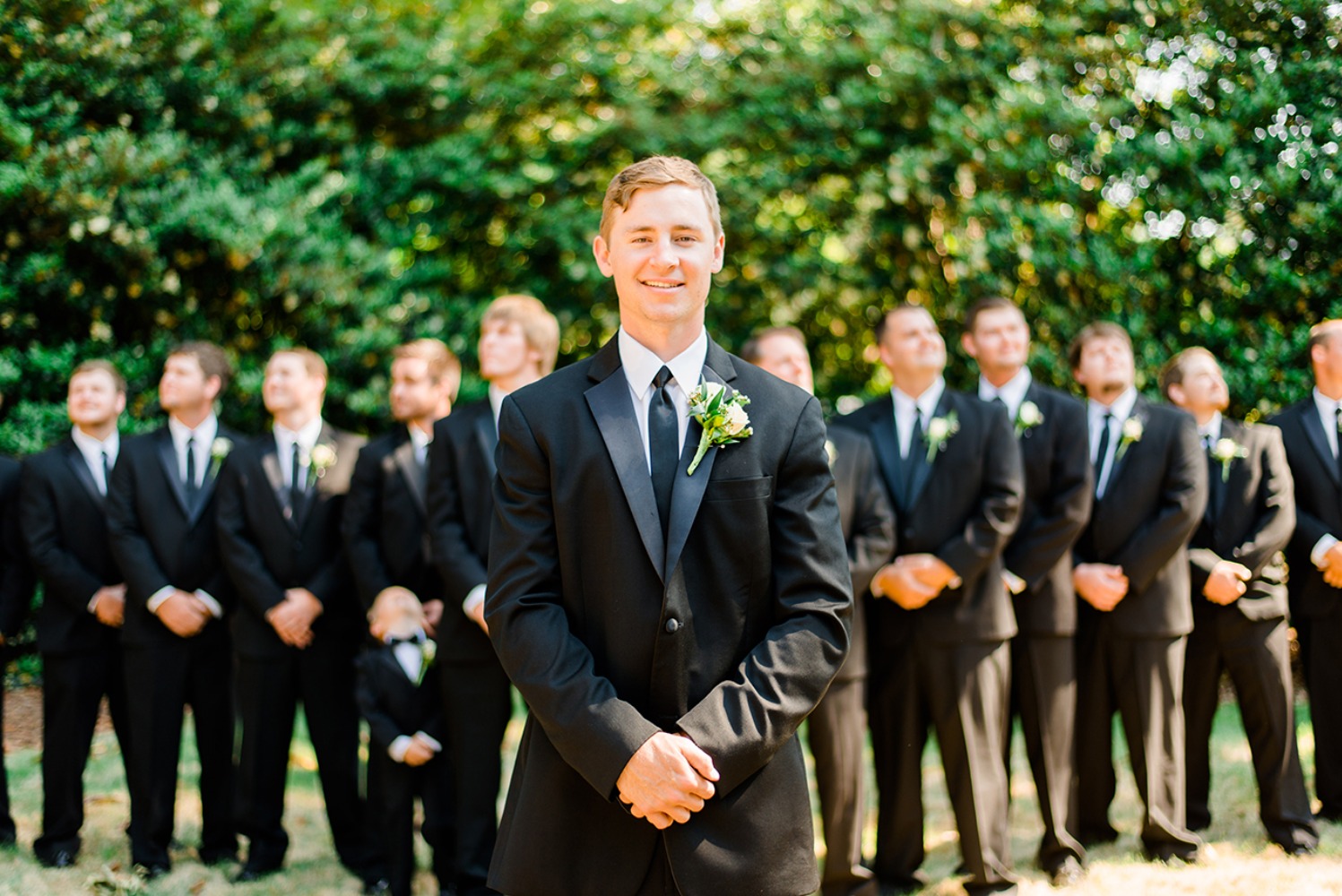 groom and groomsmen in classic black suits
