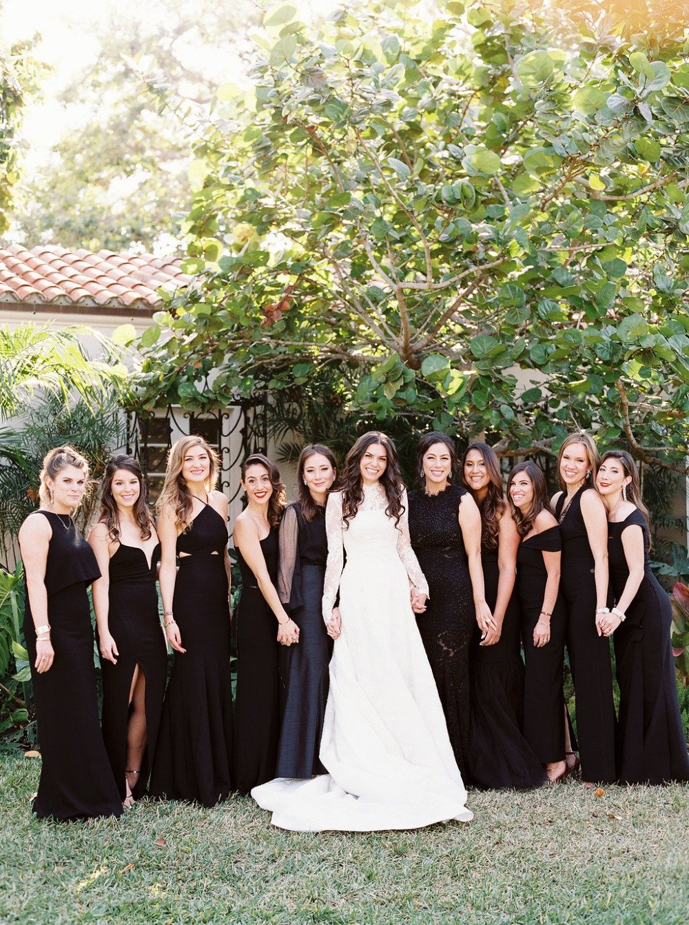 bride and all her bridesmaids in mismatched black gowns