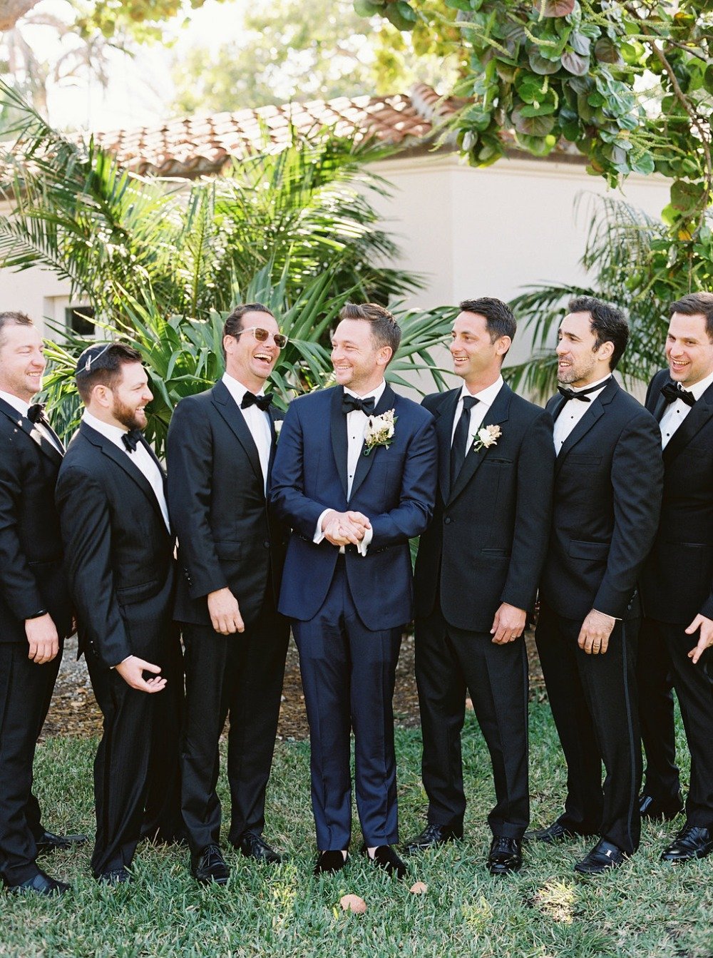 groom in navy and groomsmen in black tie
