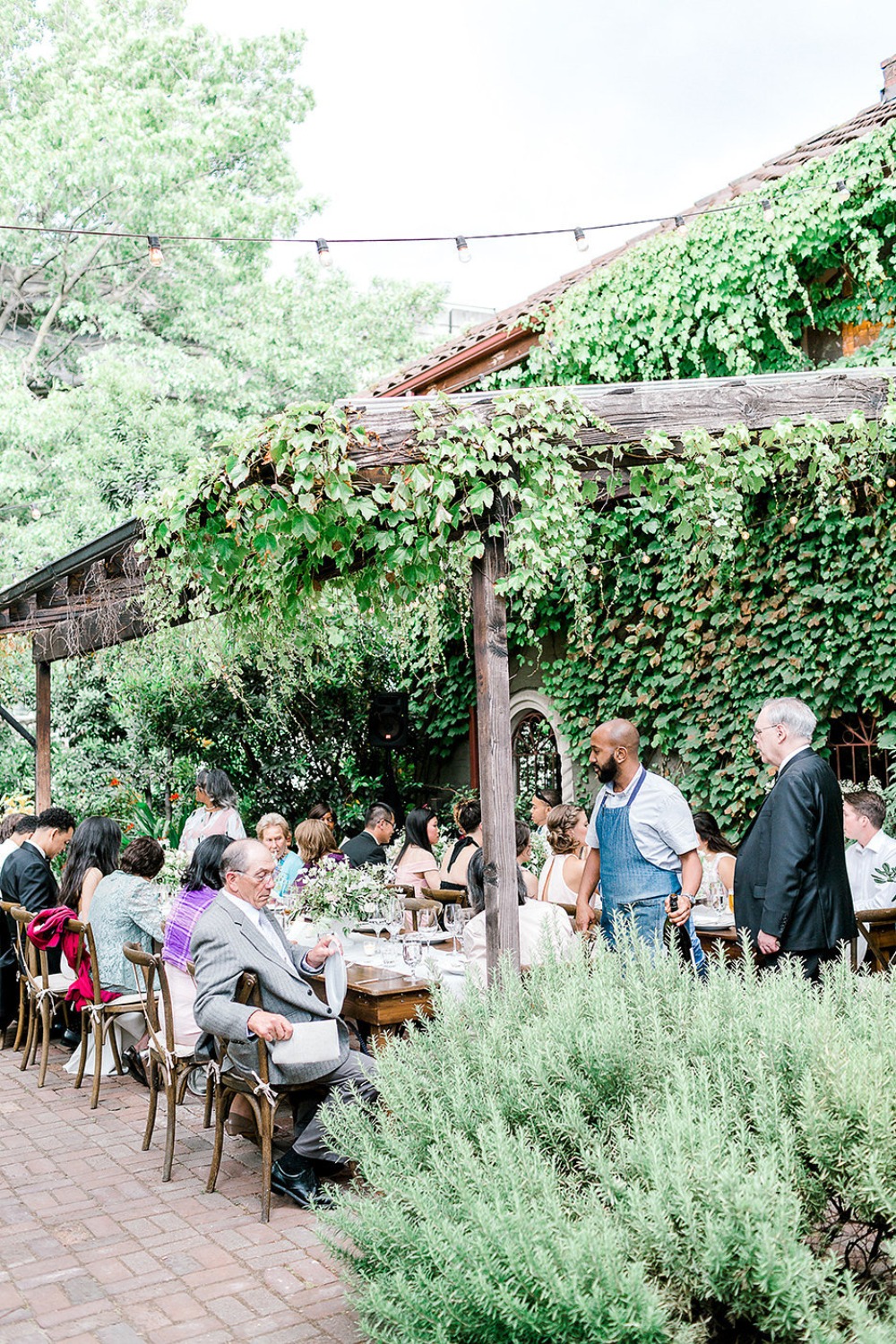 Outdoor wedding reception with guests seated at a table