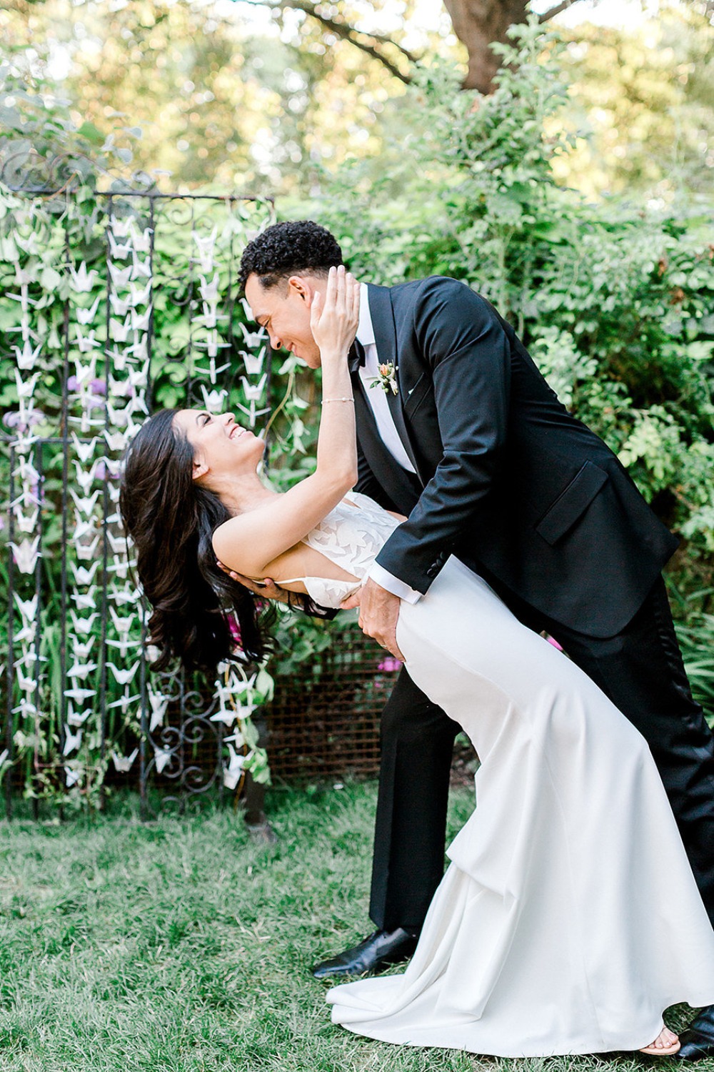 Newlyweds dancing happily at their outdoor wedding celebration