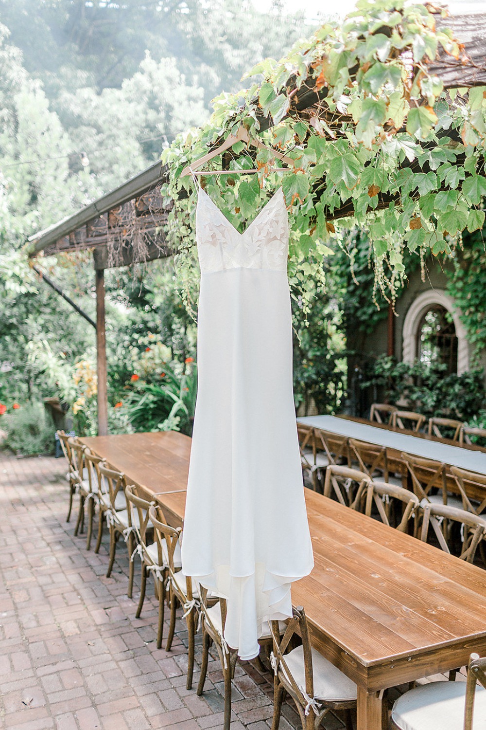Elegant wedding dress hanging outdoors ready for the big day
