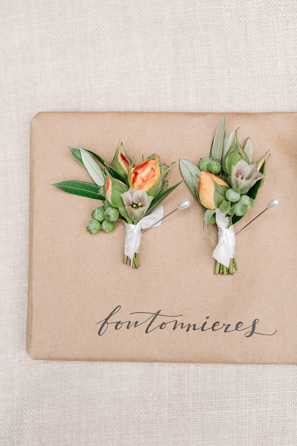 Elegant wedding boutonnieres with roses and ribbons