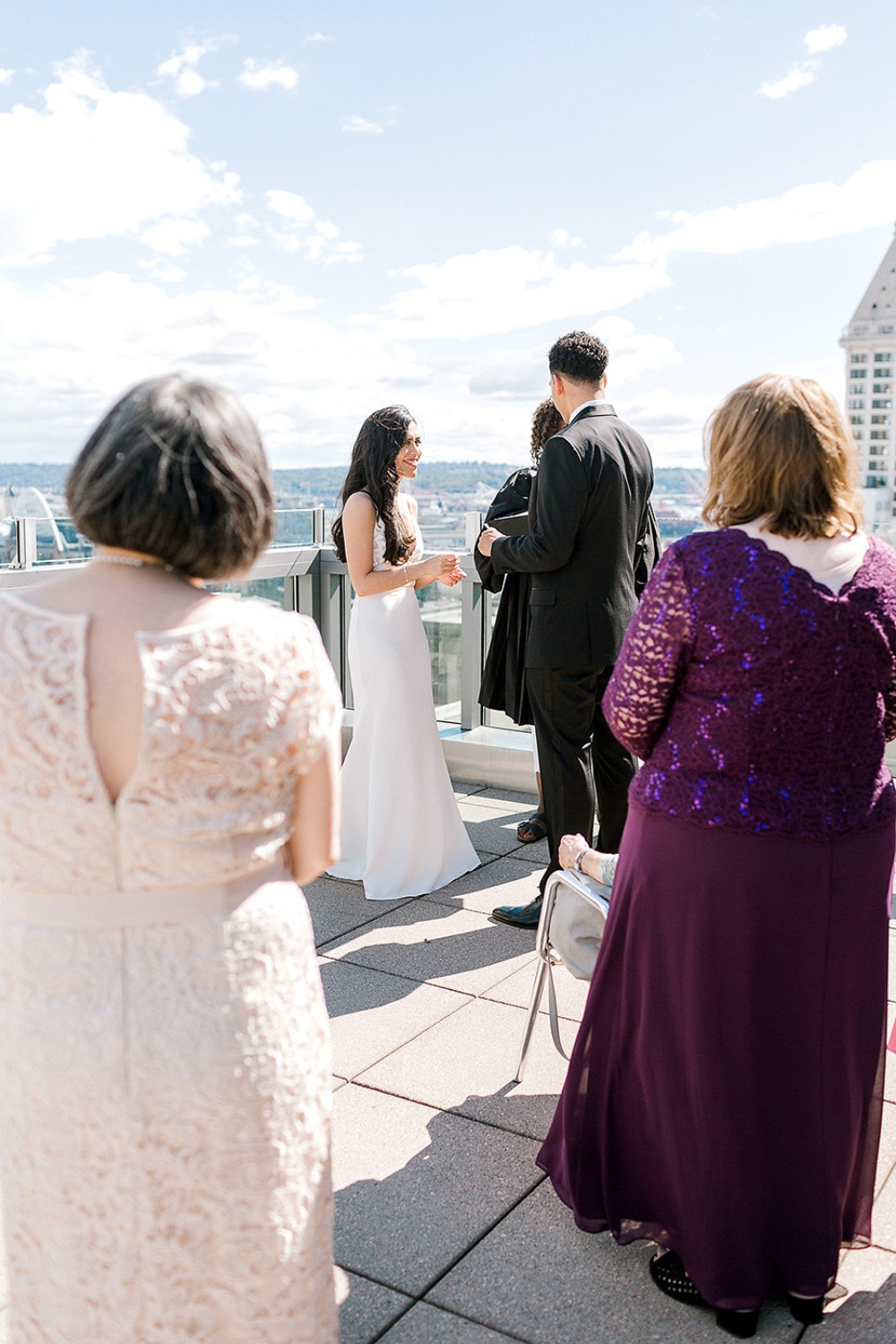 Outdoor wedding ceremony on rooftop with city view
