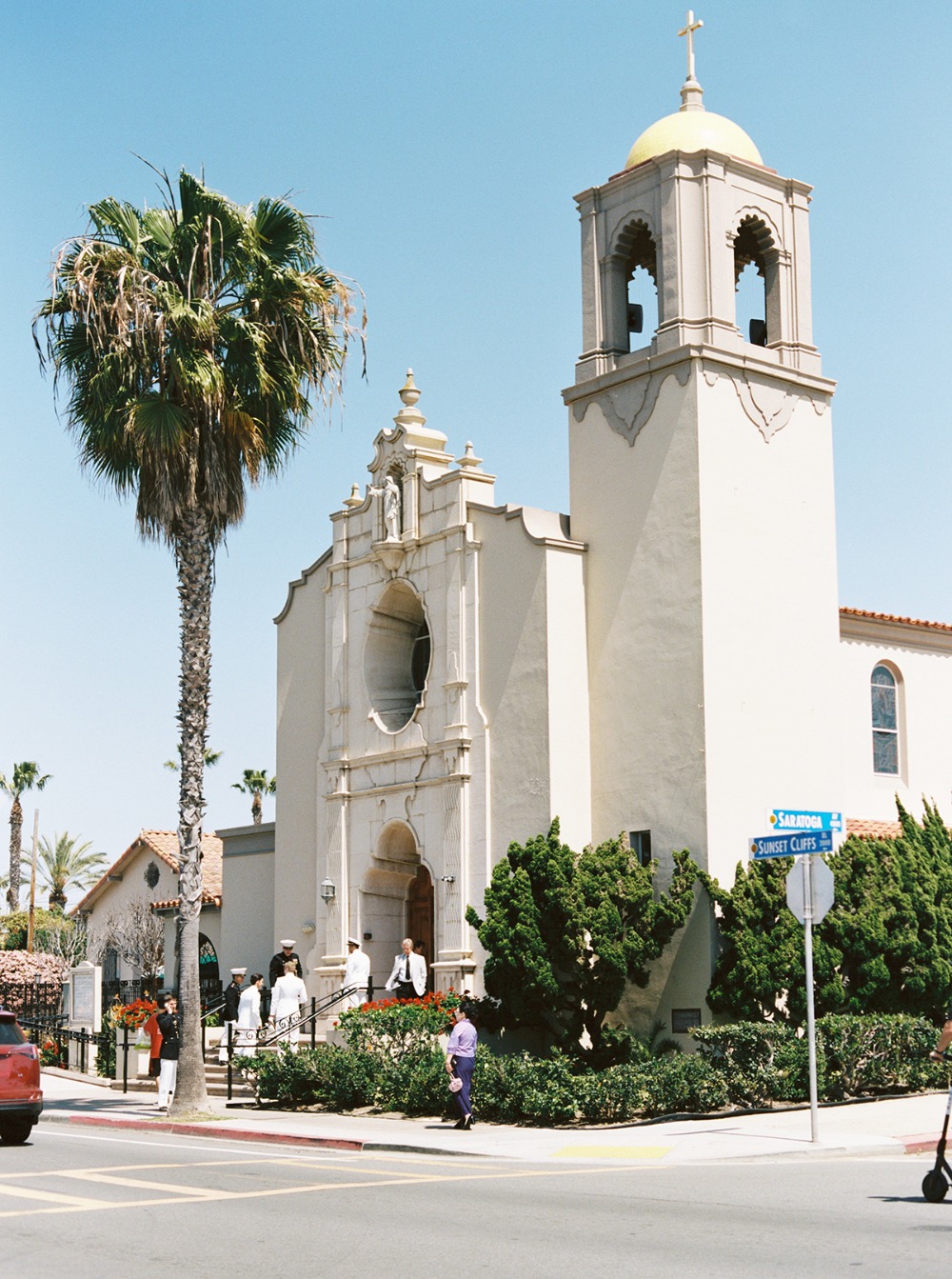 Exterior view of a beautiful church with palm trees and blue sky