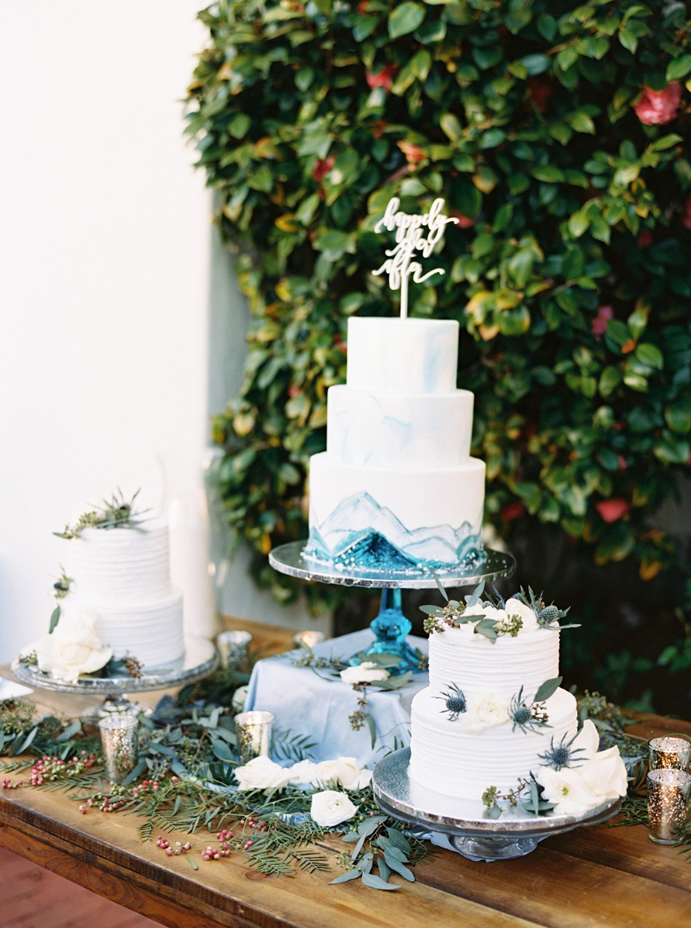 Elegant wedding cakes on dessert table with floral decor