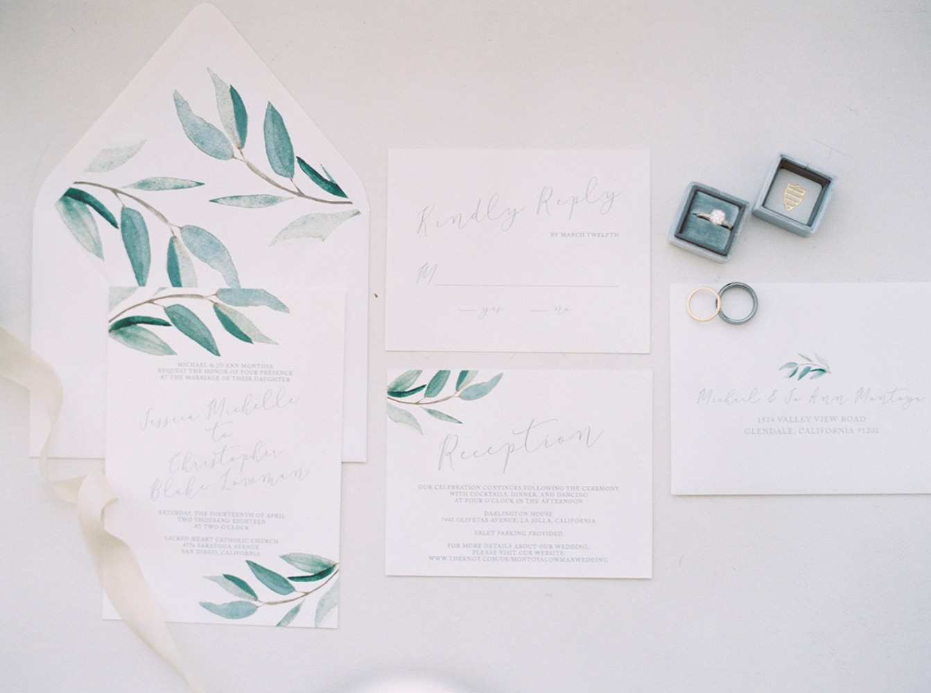 Elegant wedding invitation suite with rings and watercolor leaves