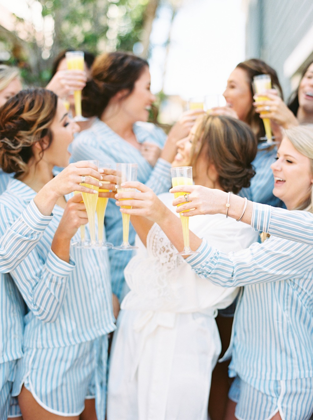 Bridesmaids celebrate with champagne flutes before the wedding