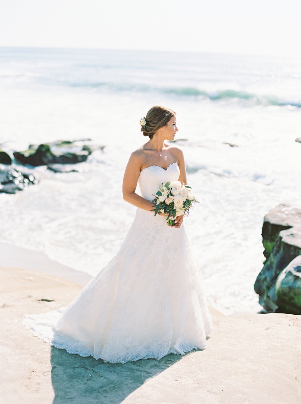 Bride in white dress at ocean wedding location