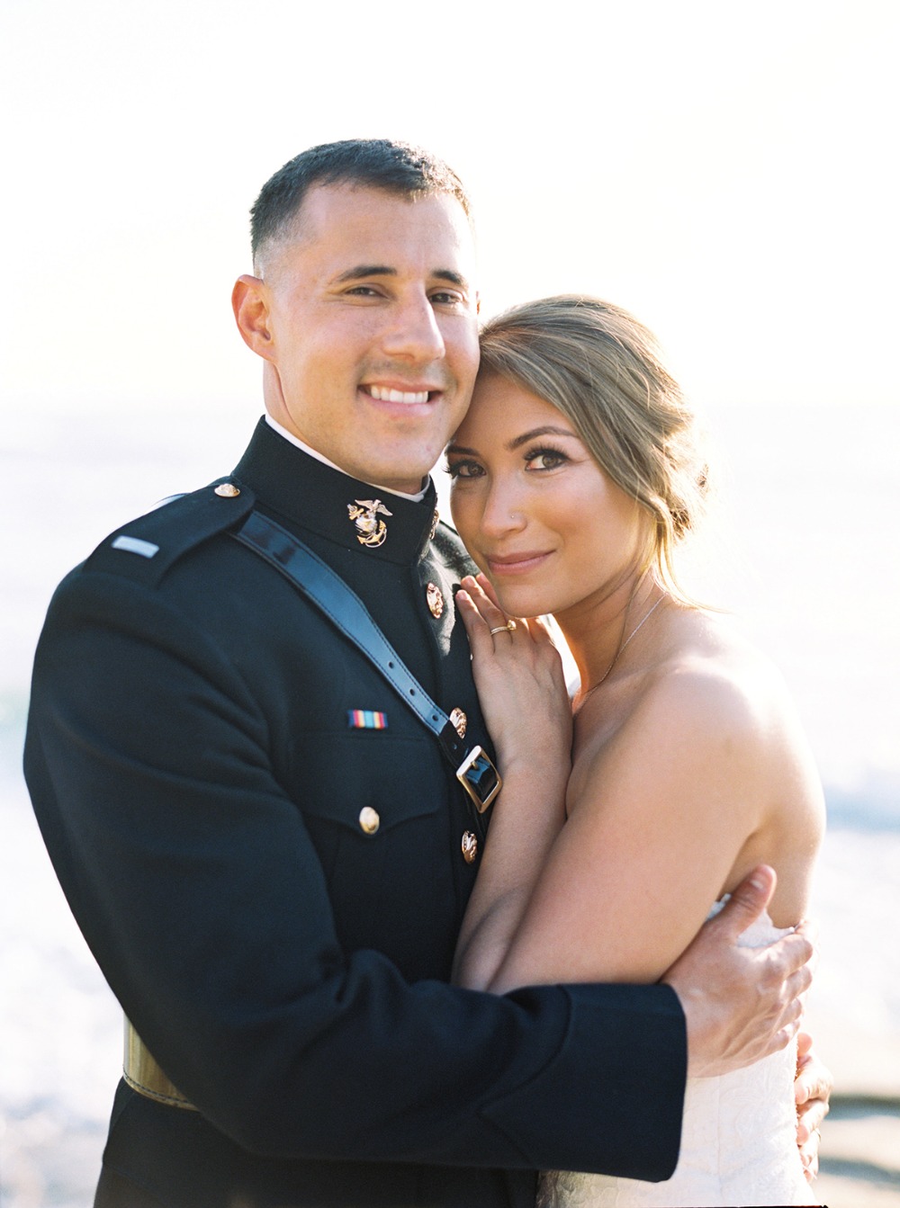 Happy couple in uniform on their wedding day, smiling