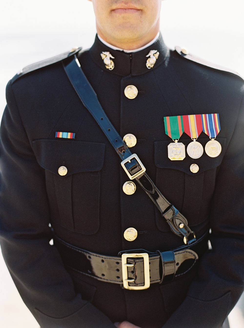 Marine in dress uniform with medals and awards displayed