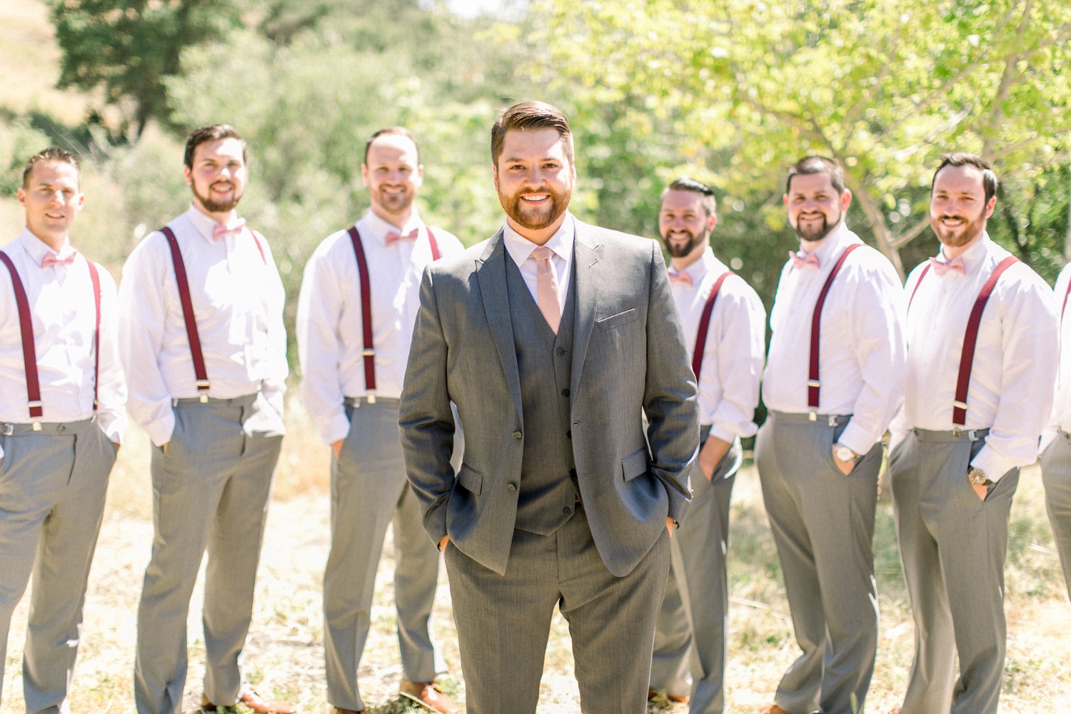 groom and his groomsmen in grey and pink