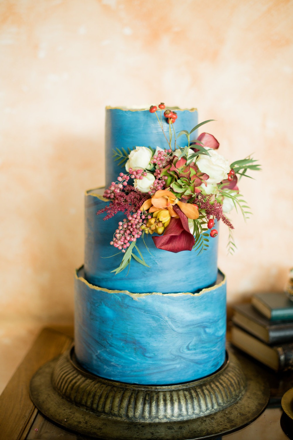 Marbled blue and gold cake with floral accent