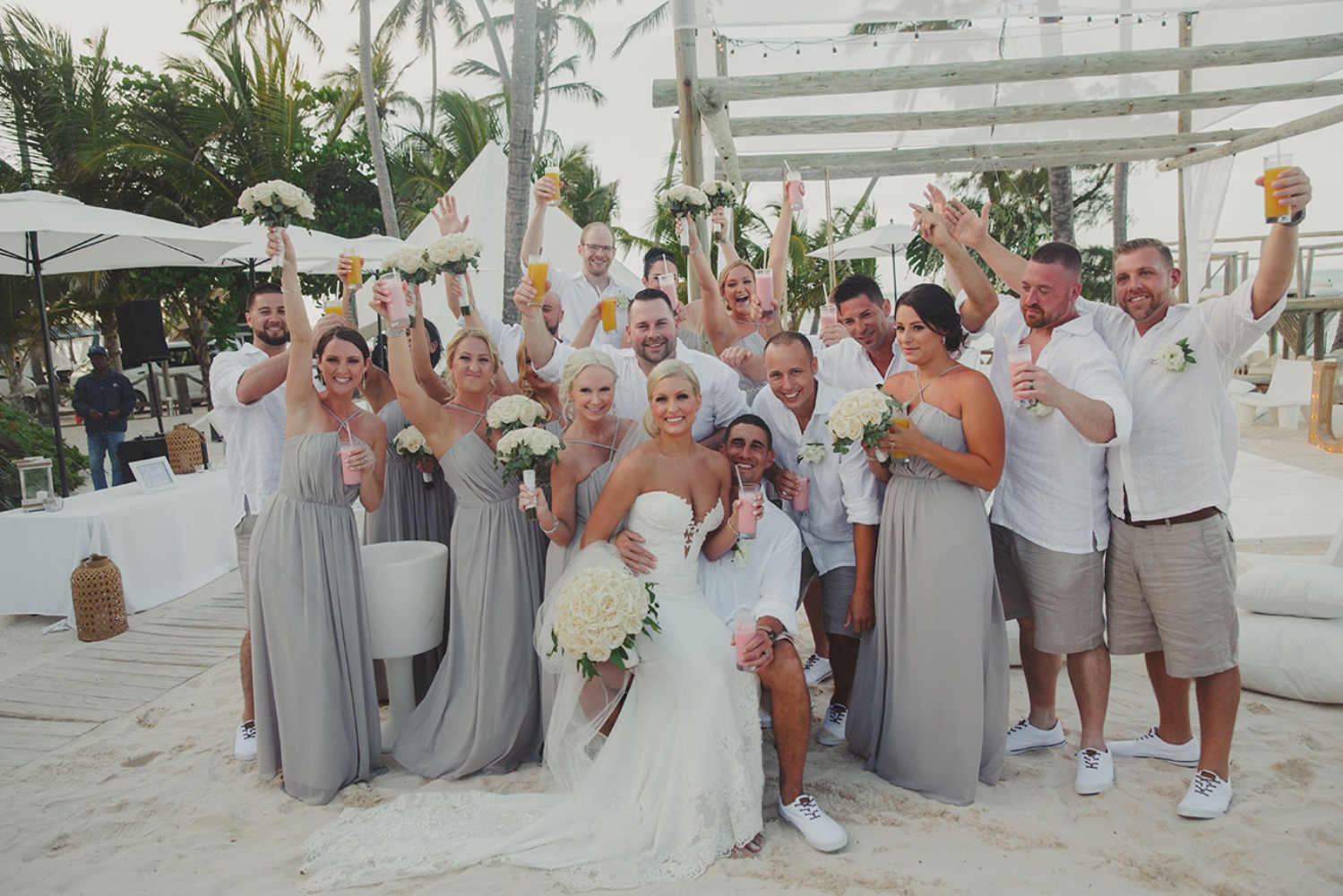 Bride groom and party toast at beach wedding venue
