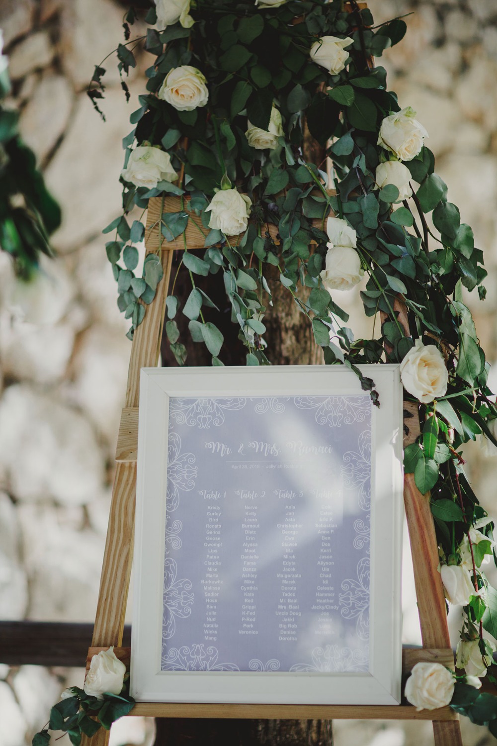 Wedding seating chart with floral decorations around it