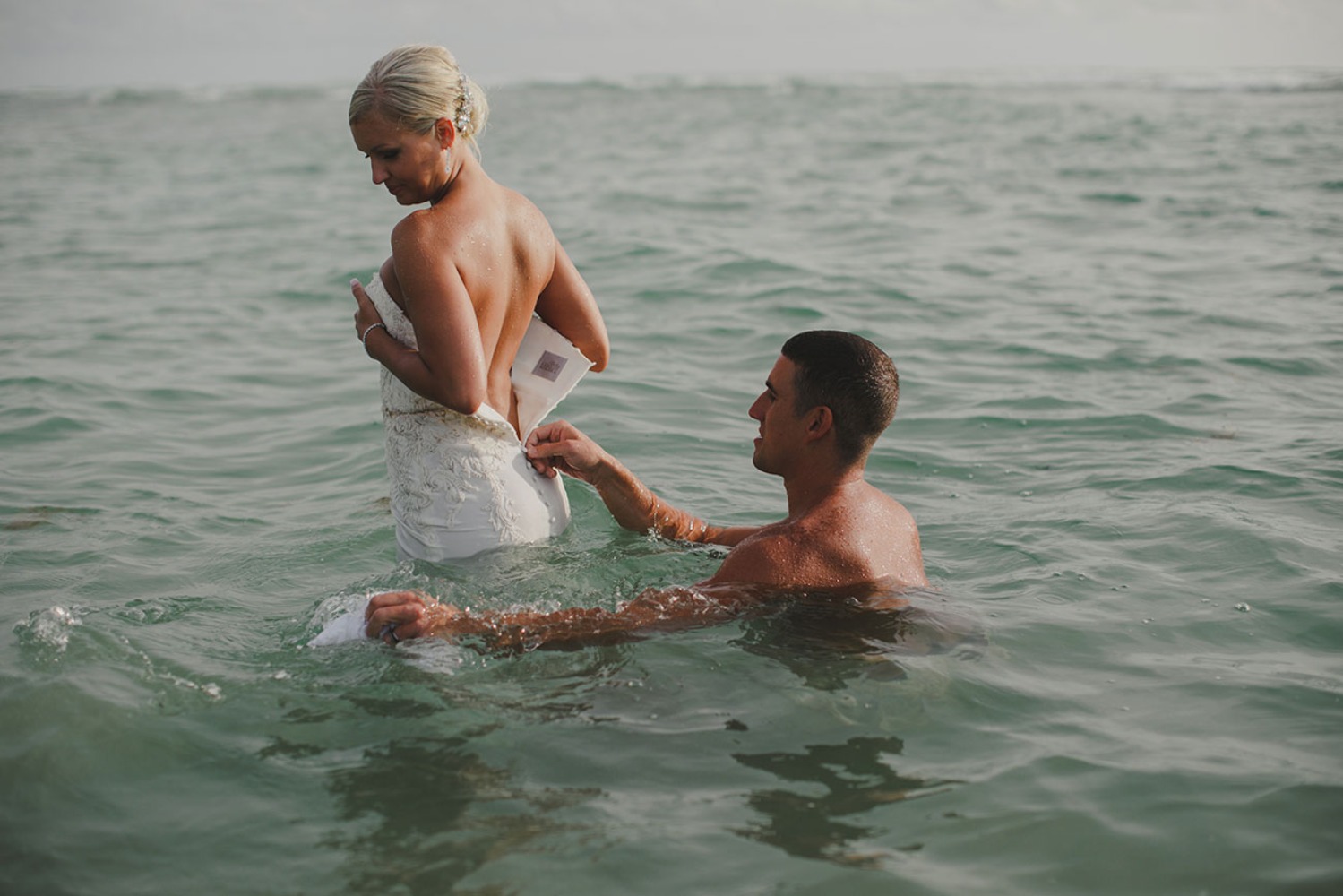 Bride and Groom share a romantic moment in the ocean on their wedding day