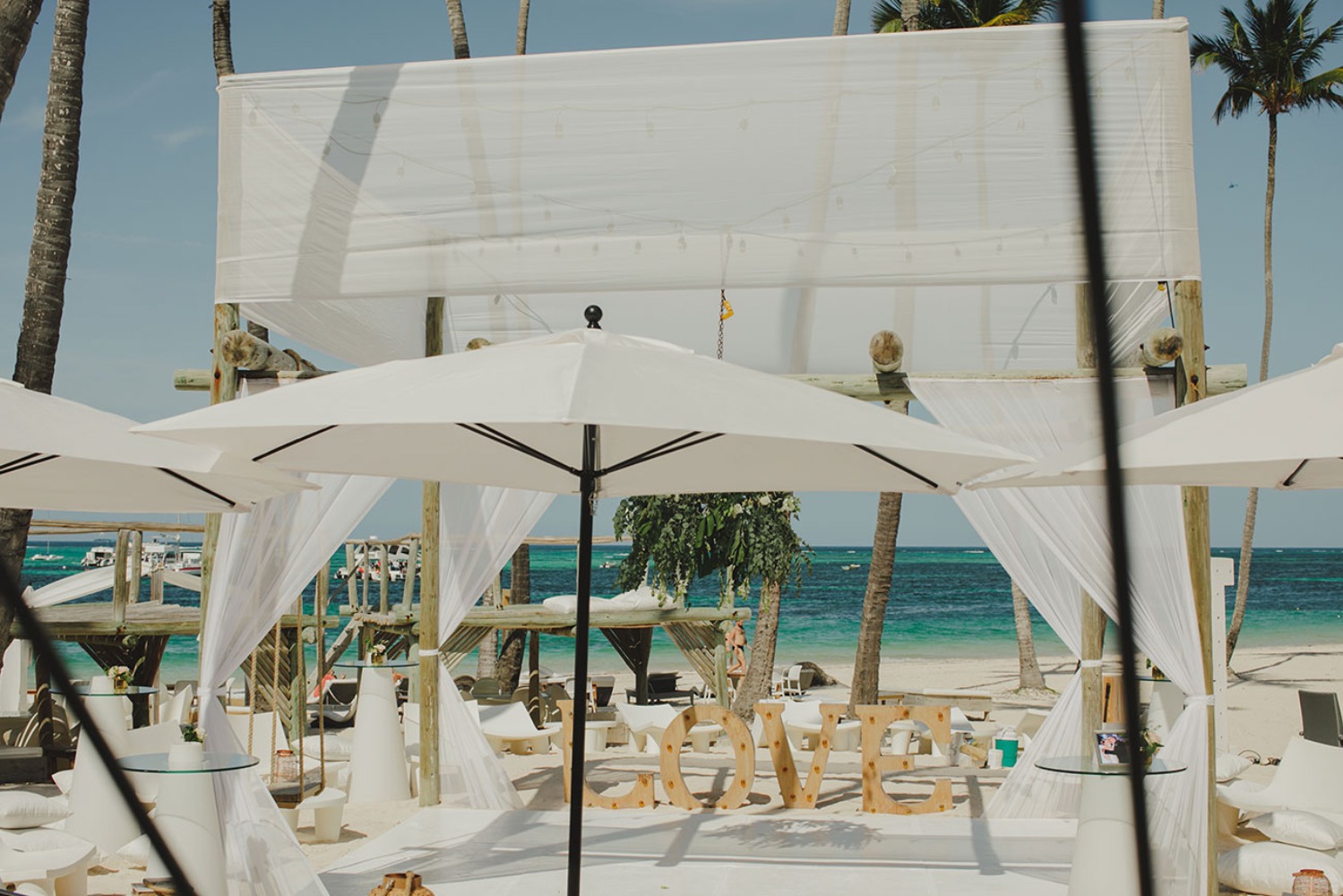 Romantic beach wedding venue setup with LOVE signage