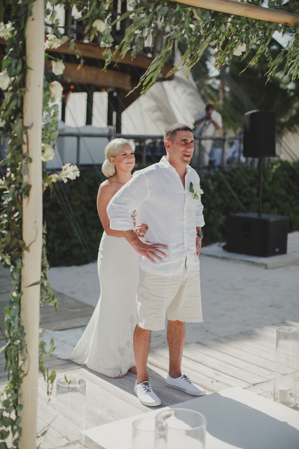Bride and groom smiling at their beach wedding ceremony