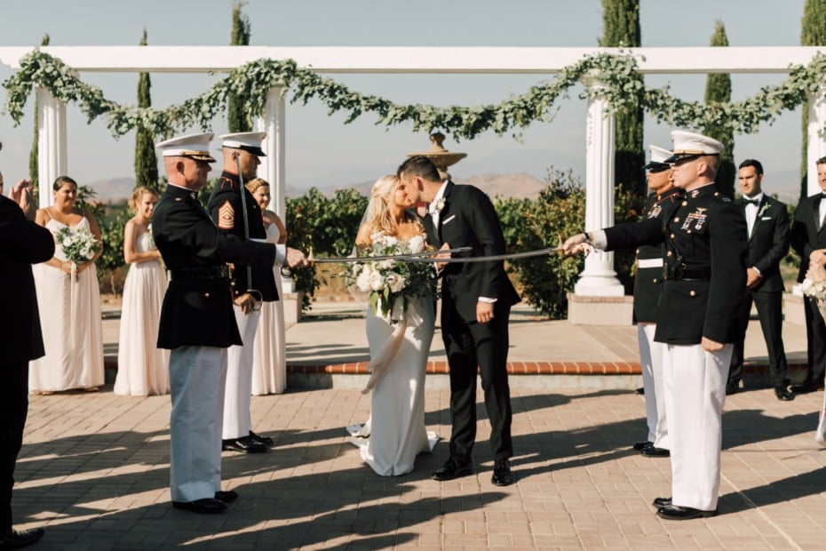 first kiss as a married couple under a sword arch