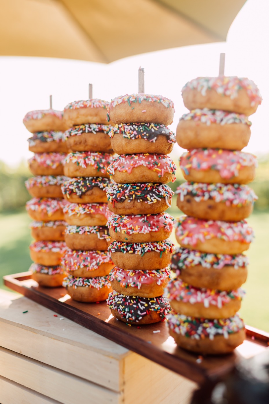 Stacks of colorful sprinkle donuts on display
