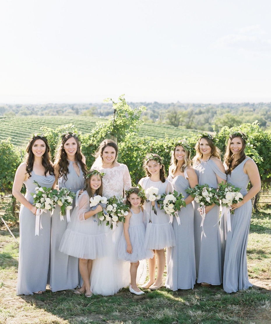 Bridal party in periwinkle over a field