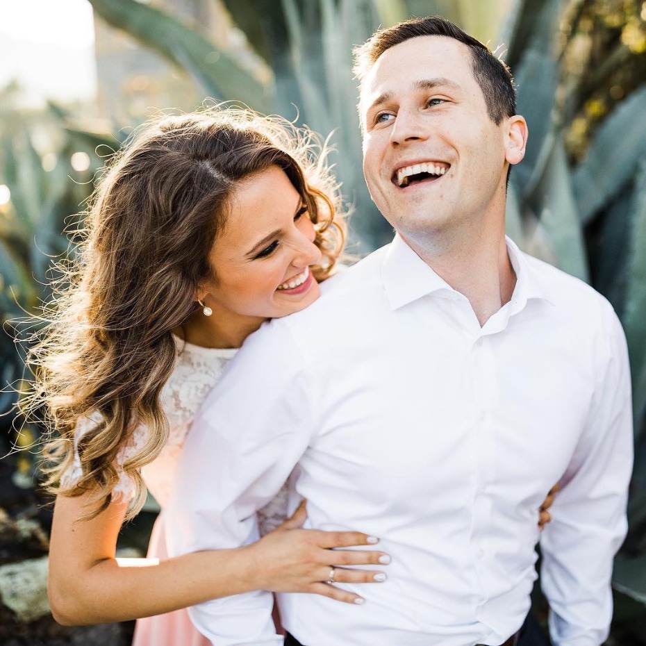 Happy couple embracing outdoors, joyful engagement photo