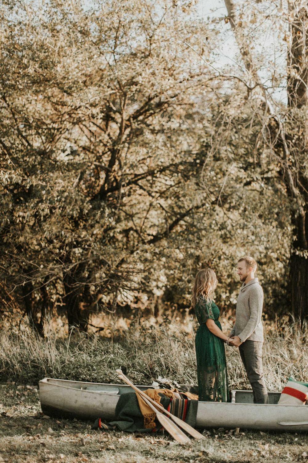 Couple in canoe holding hands romantic nature scene