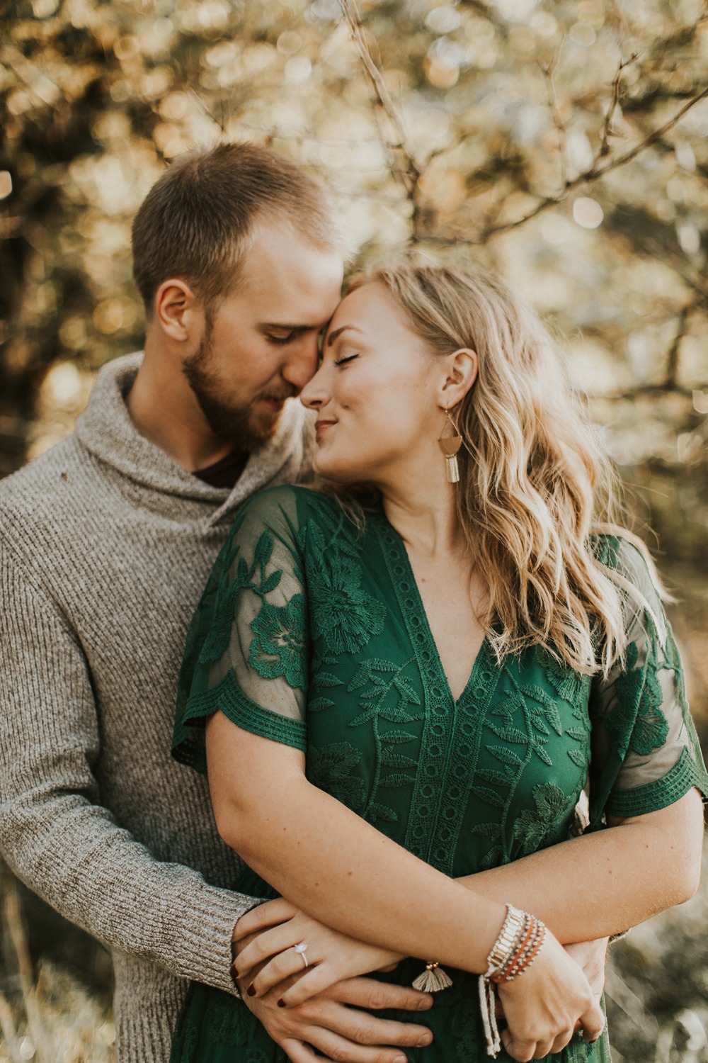 Romantic couple embraces lovingly in soft outdoor light