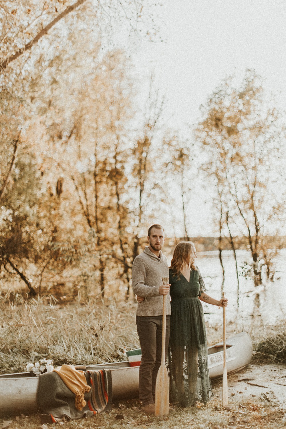 Serene couple with canoe on a peaceful lake shore