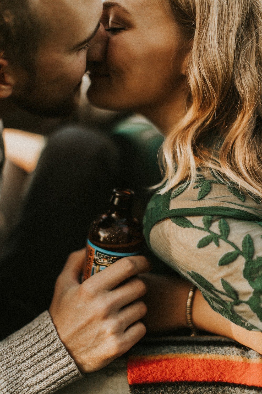 Lovers sharing an intimate moment and a beer