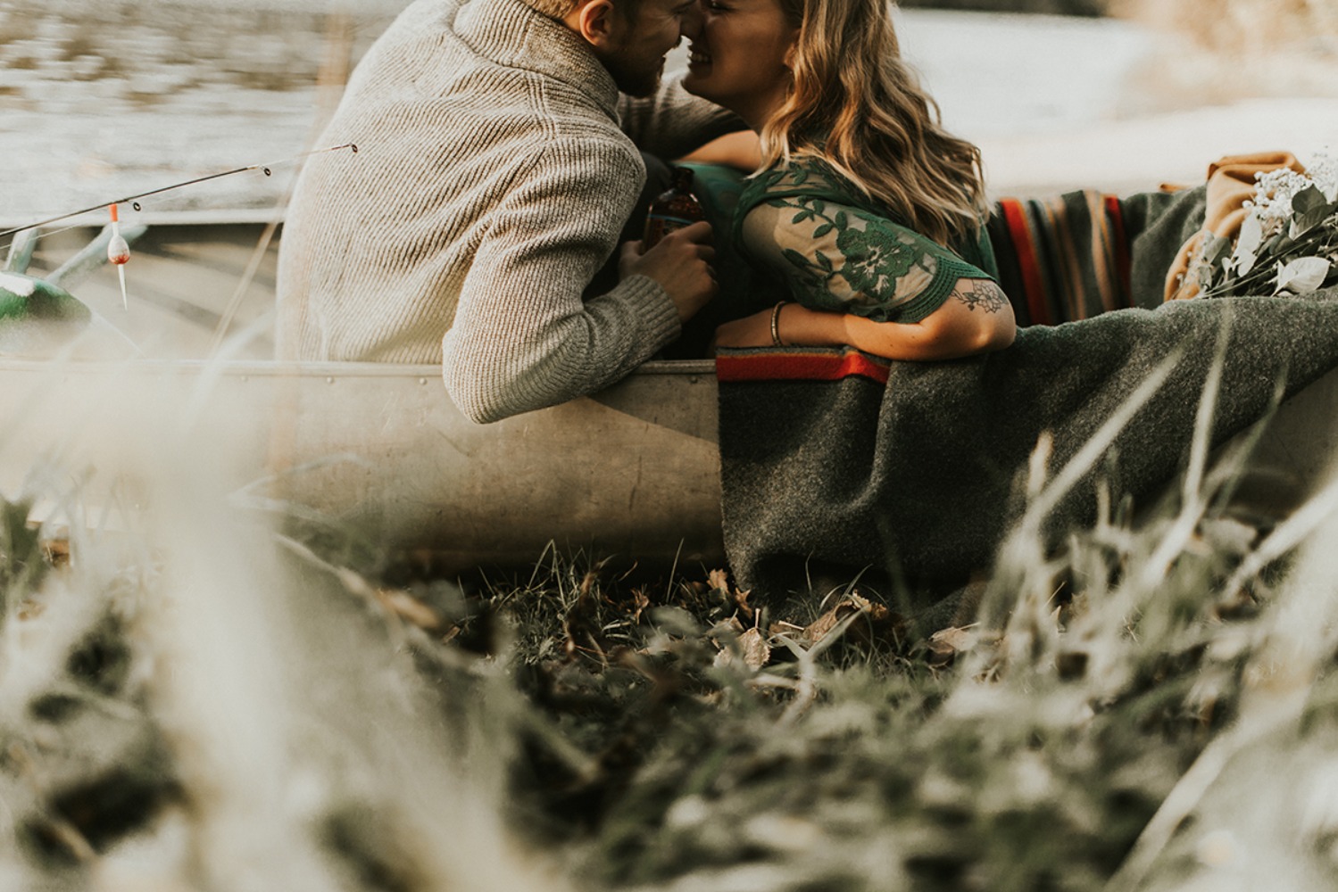 Couple sharing romantic kiss in canoe lake fishing