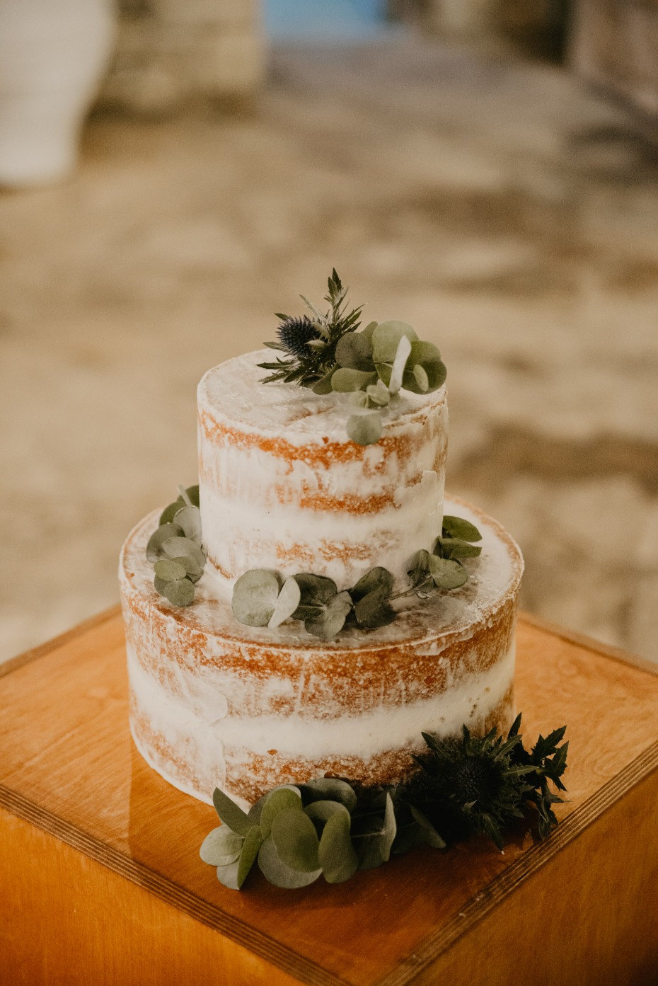 Naked wedding cake with greenery