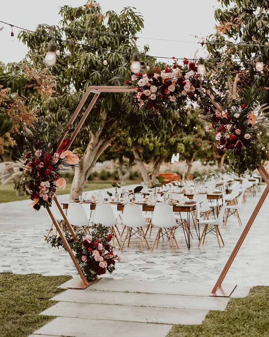 Outdoor wedding reception with floral archway