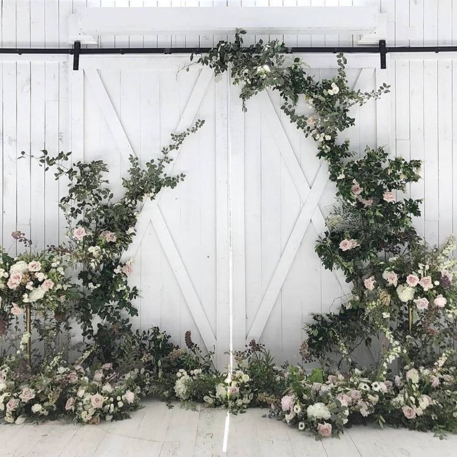 Elegant floral archway decoration on white barn door