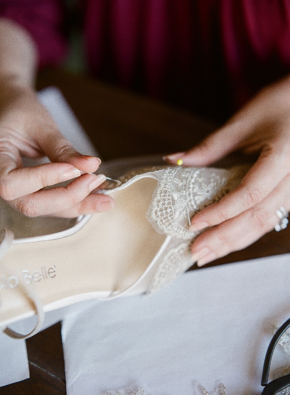 Adding lace to wedding shoes by hand