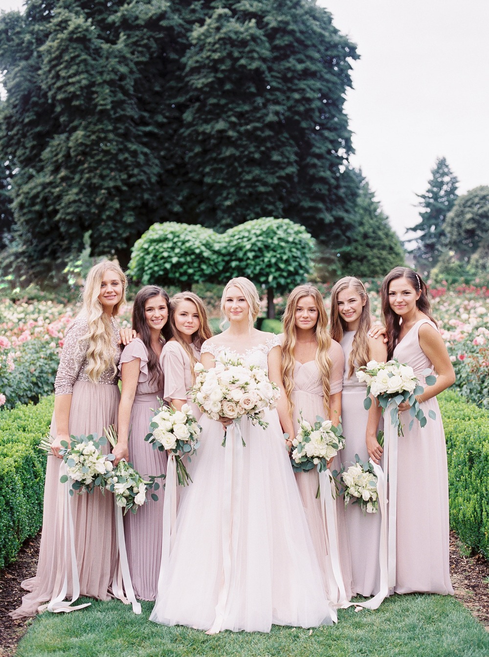 Bridesmaids in mismatched blush dresses