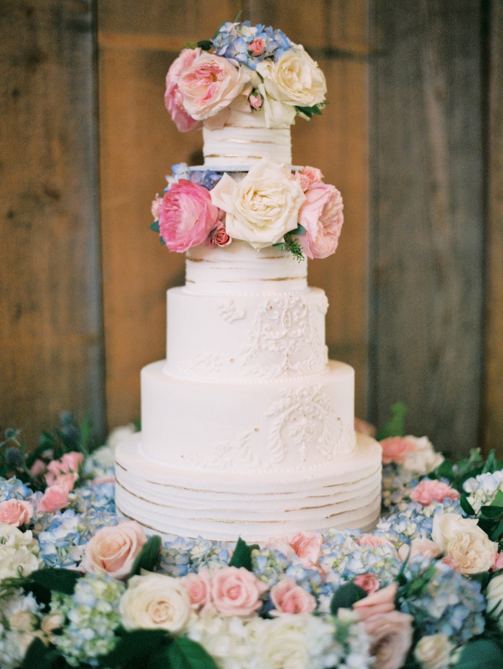 White and gold wedding cake with florals