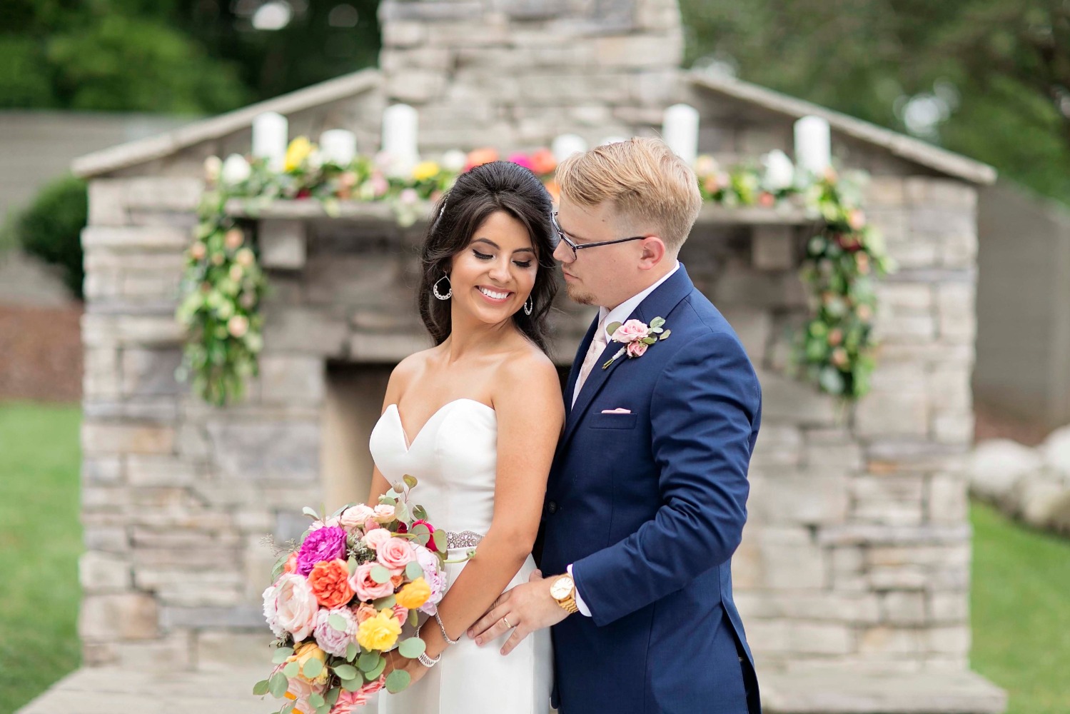 wedding couple with outdoor fireplace ceremony backdrop